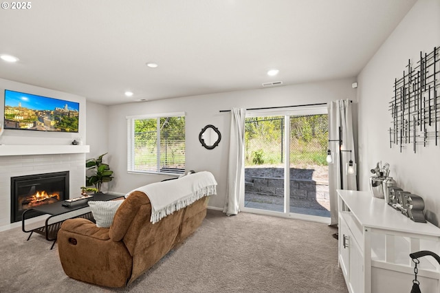 living room featuring recessed lighting, visible vents, and light colored carpet