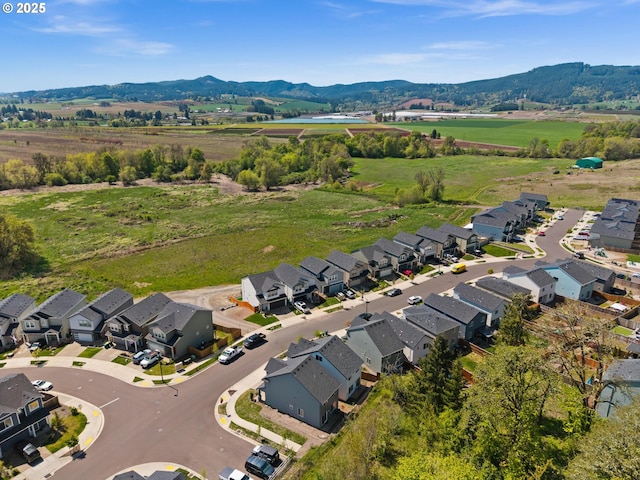 drone / aerial view with a rural view, a residential view, and a mountain view