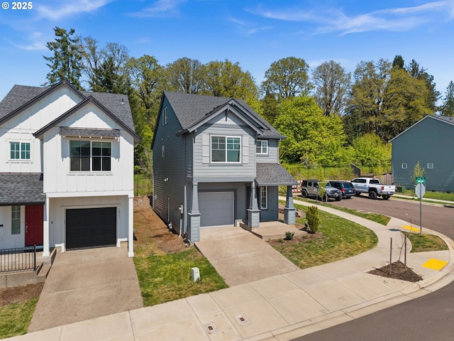 traditional-style house with an attached garage, a shingled roof, board and batten siding, and concrete driveway