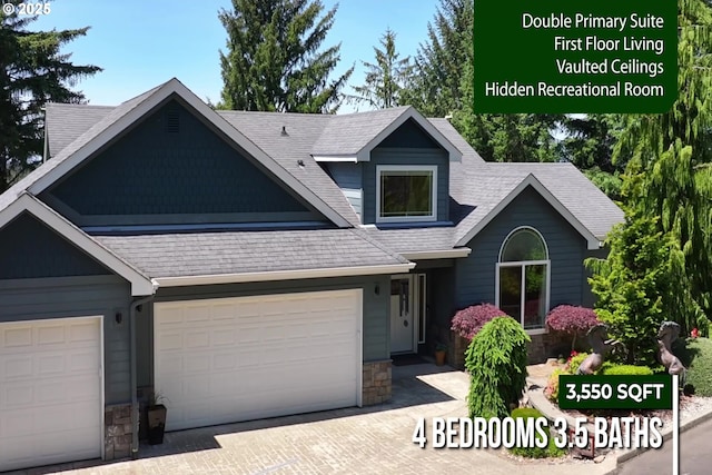 3563 Jake Mann Ln, Florence, OR 97439 - view of front of house with stone siding, a garage, decorative driveway, and a shingled roof