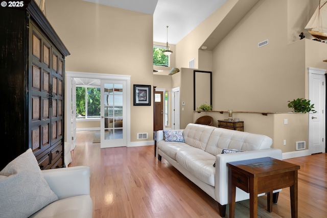 3563 Jake Mann Ln, Florence, OR 97439 - living area featuring a high ceiling, baseboards, french doors, and light wood-style flooring