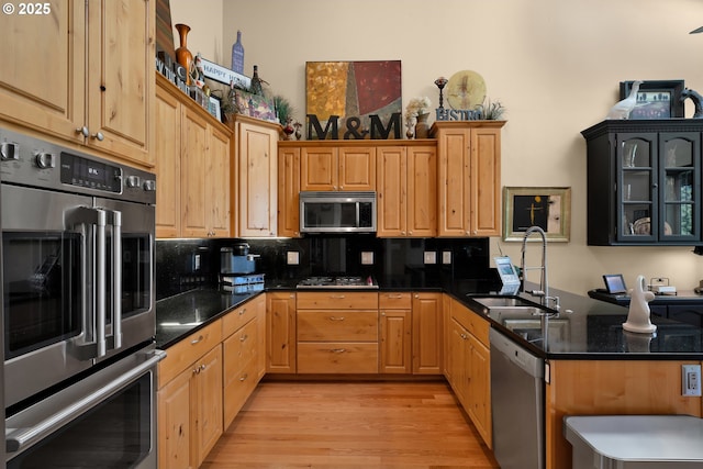 3563 Jake Mann Ln, Florence, OR 97439 - kitchen with appliances with stainless steel finishes, a sink, light wood finished floors, tasteful backsplash, and a high ceiling