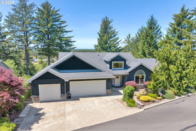 3563 Jake Mann Ln, Florence, OR 97439 - craftsman house featuring a garage, stone siding, concrete driveway, and roof with shingles