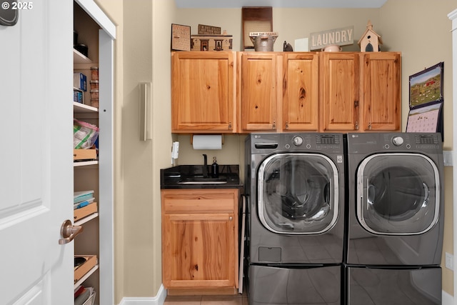 3563 Jake Mann Ln, Florence, OR 97439 - laundry room featuring cabinet space, washing machine and clothes dryer, light tile patterned floors, and baseboards