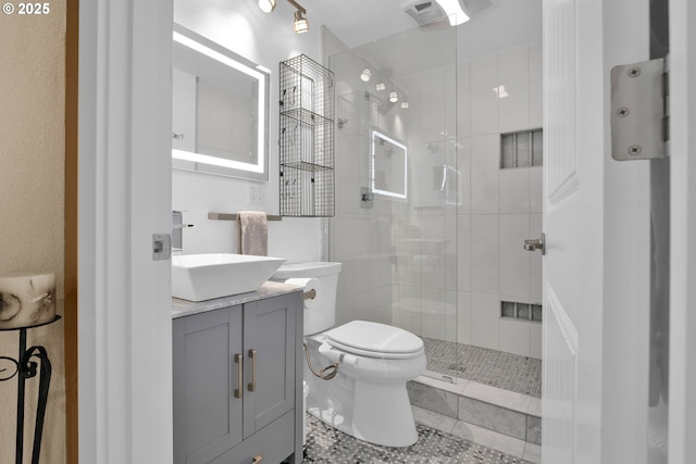 3563 Jake Mann Ln, Florence, OR 97439 - bathroom featuring toilet, a stall shower, vanity, and tile patterned flooring