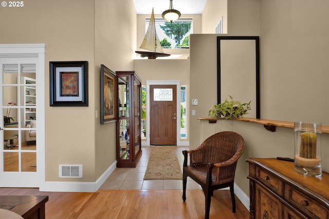 3563 Jake Mann Ln, Florence, OR 97439 - entryway with baseboards, a high ceiling, and light wood-type flooring