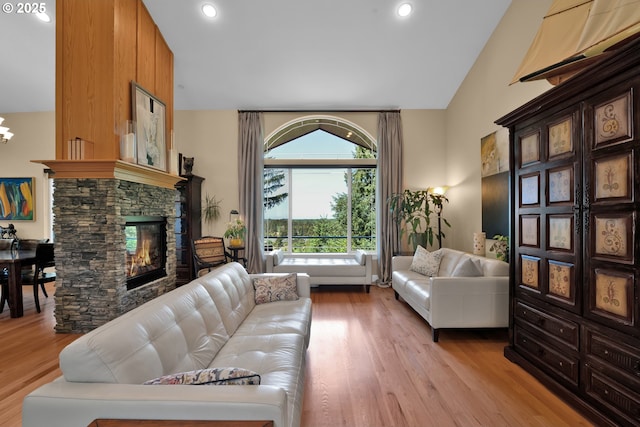 3563 Jake Mann Ln, Florence, OR 97439 - living area featuring a fireplace, vaulted ceiling, light wood finished floors, and recessed lighting