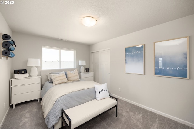 carpeted bedroom with a closet and a textured ceiling