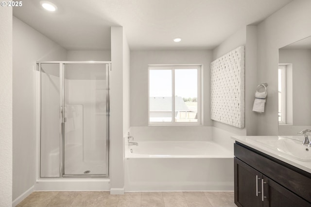 bathroom featuring vanity, tile patterned floors, and shower with separate bathtub