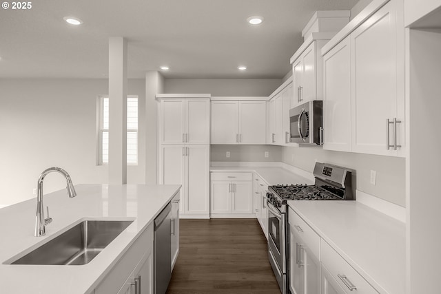 kitchen featuring appliances with stainless steel finishes, sink, and white cabinets