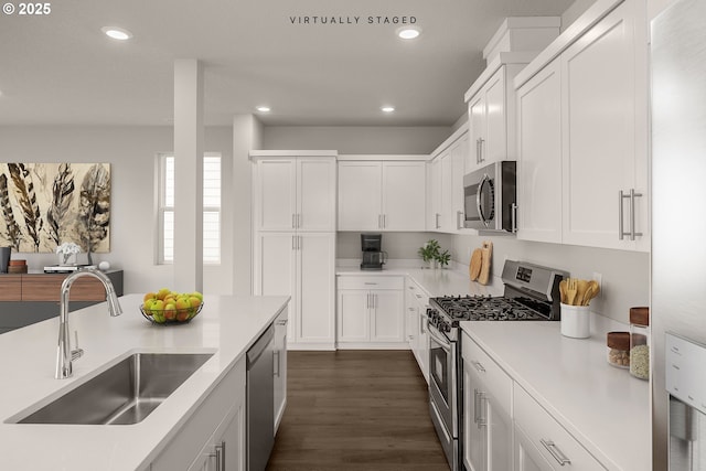 kitchen featuring white cabinetry, sink, and appliances with stainless steel finishes