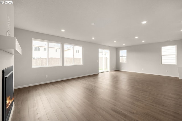 unfurnished living room with dark hardwood / wood-style flooring