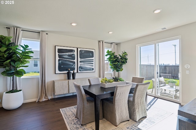 dining room featuring plenty of natural light and dark hardwood / wood-style floors