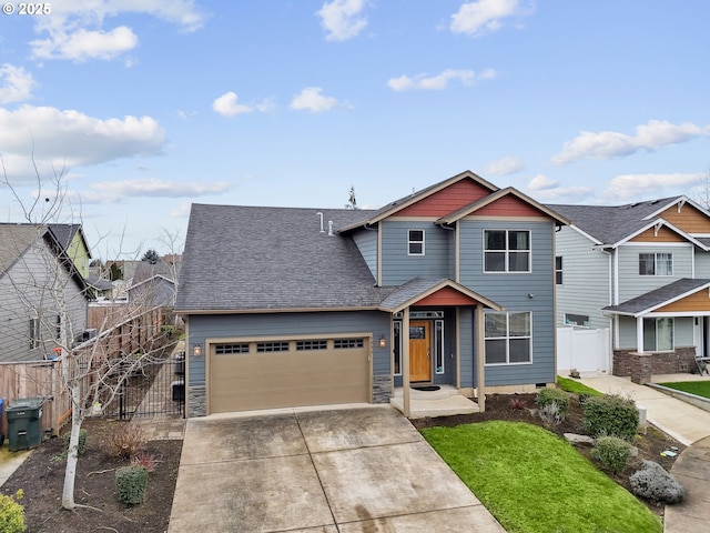 view of front of house featuring a garage, a shingled roof, concrete driveway, a gate, and fence