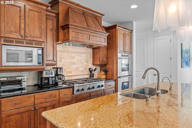 100 Garibaldi St, Lake Oswego, OR 97035 - kitchen with stainless steel appliances, custom range hood, dark stone countertops, brown cabinetry, and decorative backsplash