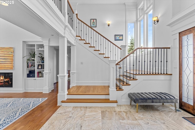 100 Garibaldi St, Lake Oswego, OR 97035 - entrance foyer featuring plenty of natural light, a glass covered fireplace, stairs, and a towering ceiling