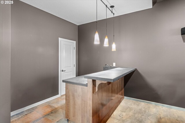 100 Garibaldi St, Lake Oswego, OR 97035 - kitchen with a peninsula, a kitchen breakfast bar, hanging light fixtures, light stone finish floors, and rail lighting