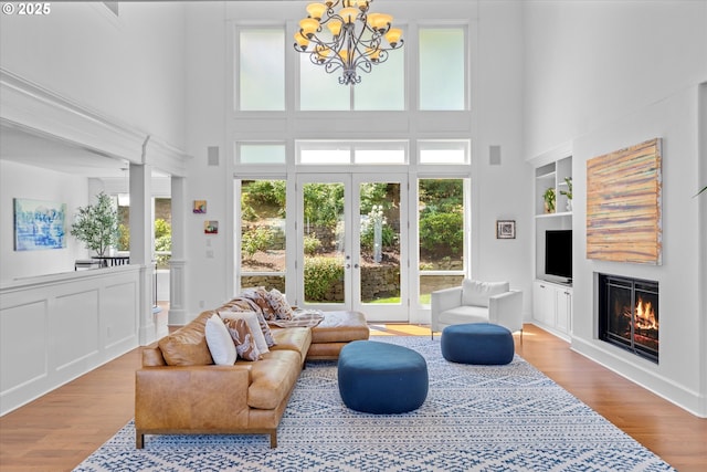 100 Garibaldi St, Lake Oswego, OR 97035 - living room featuring a glass covered fireplace, plenty of natural light, built in features, and a high ceiling