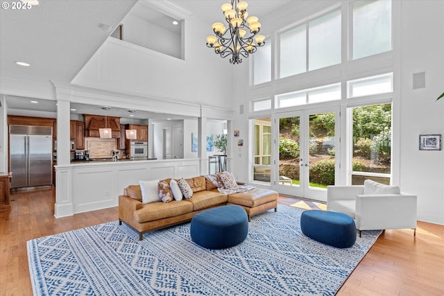 100 Garibaldi St, Lake Oswego, OR 97035 - living room featuring light wood finished floors, a chandelier, and a high ceiling