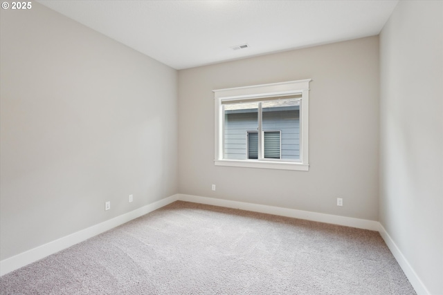 carpeted spare room with baseboards
