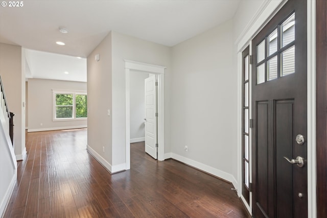entrance foyer with dark wood-type flooring, baseboards, and recessed lighting