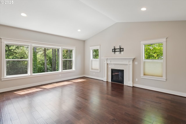 unfurnished living room featuring plenty of natural light, vaulted ceiling, wood finished floors, baseboards, and recessed lighting