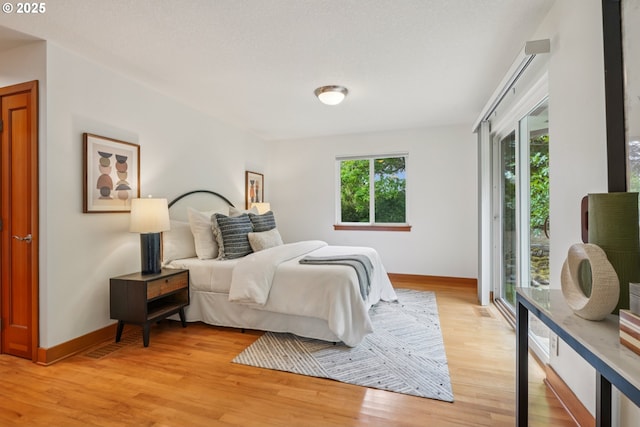 630 SW Viewmont Dr, Portland, OR 97225 - bedroom featuring baseboards, light wood-style floors, and access to exterior