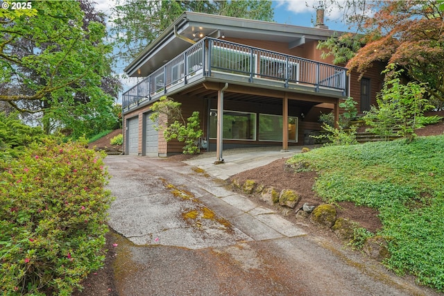 630 SW Viewmont Dr, Portland, OR 97225 - view of front of home with a garage, asphalt driveway, and a balcony