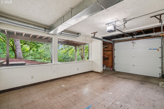 630 SW Viewmont Dr, Portland, OR 97225 - garage featuring baseboards and a garage door opener