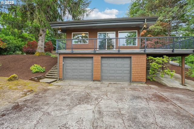 630 SW Viewmont Dr, Portland, OR 97225 - view of front of home with a garage, driveway, stairs, and a balcony