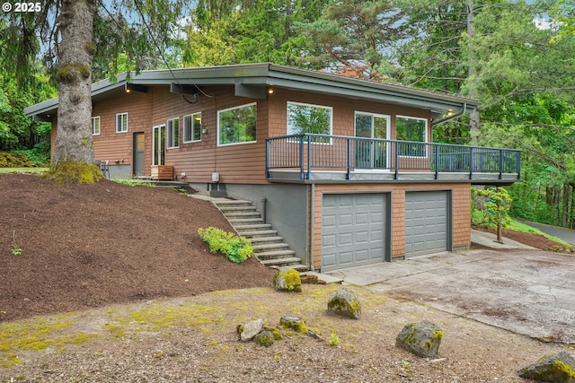 630 SW Viewmont Dr, Portland, OR 97225 - view of front facade with stairway, a garage, and concrete driveway