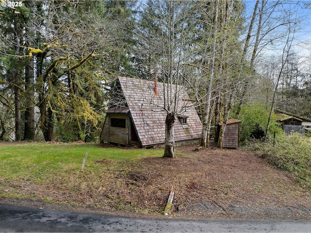 view of property exterior with an outdoor structure