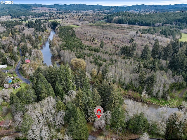 bird's eye view featuring a forest view and a water and mountain view