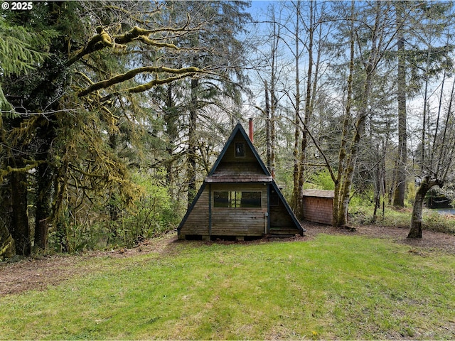 exterior space with a yard and an outdoor structure
