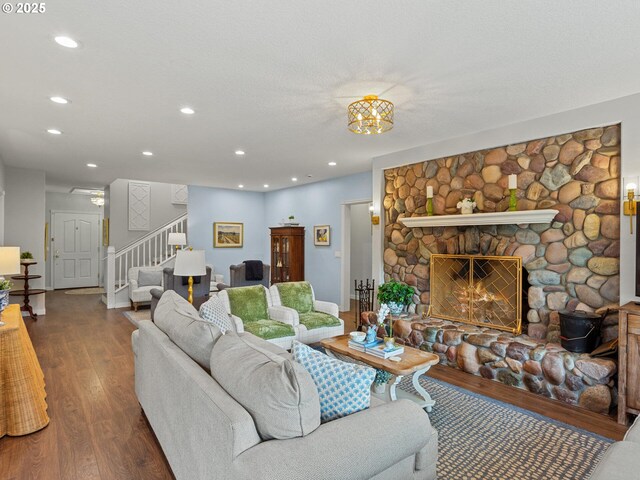 living area with recessed lighting, baseboards, stairs, and wood finished floors
