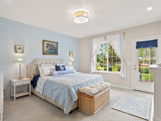 carpeted bedroom featuring baseboards, access to outside, and multiple windows