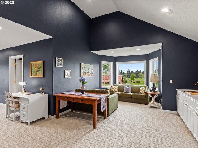 living room with high vaulted ceiling, baseboards, recessed lighting, and light colored carpet