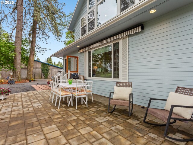 view of patio with fence and outdoor dining area