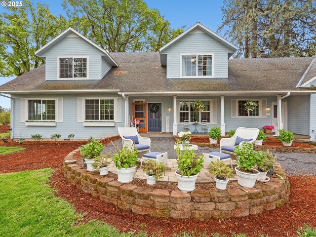 traditional-style house with roof with shingles and a patio area