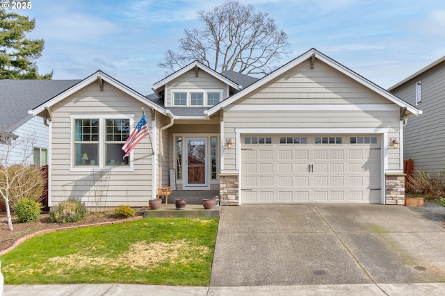 view of front of home with a garage, stone siding, and driveway