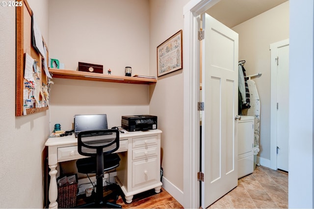 office space with washer / clothes dryer and baseboards