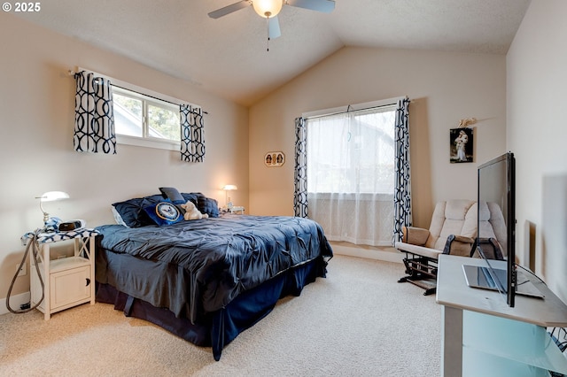 bedroom featuring light colored carpet, lofted ceiling, and ceiling fan