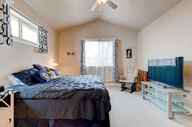 carpeted bedroom featuring a textured ceiling, ceiling fan, and vaulted ceiling