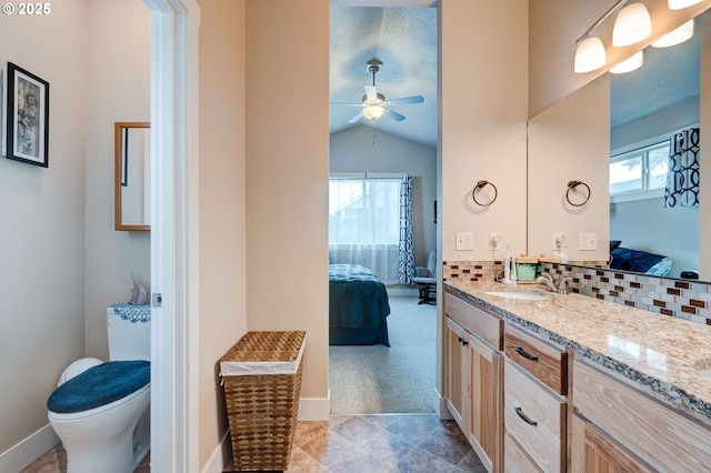 ensuite bathroom with a wealth of natural light, connected bathroom, tasteful backsplash, and vanity