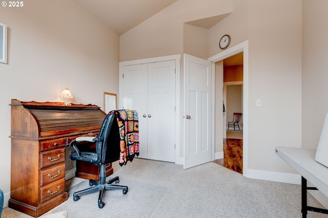 home office featuring carpet floors, baseboards, and vaulted ceiling