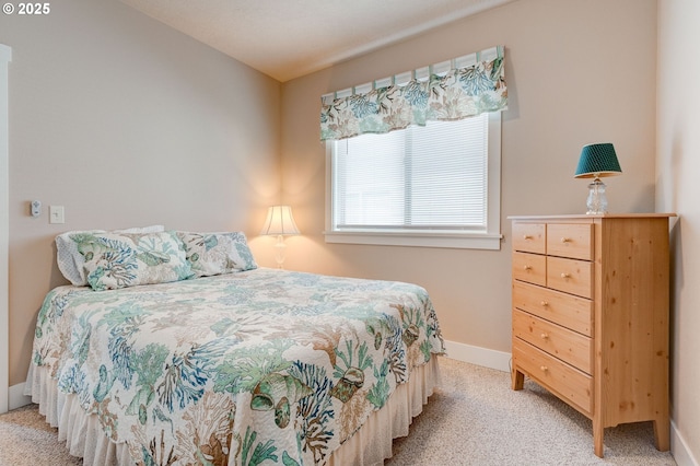 bedroom featuring baseboards and light carpet