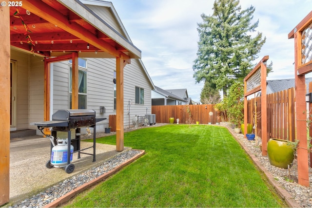 view of yard with a patio, central AC unit, and a fenced backyard