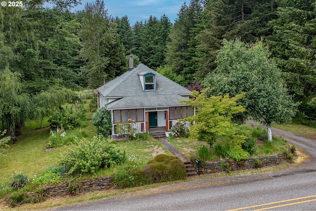 10303 SE Bull Run Rd, Corbett, OR 97019 - view of front facade with a porch, a chimney, a forest view, and roof with shingles