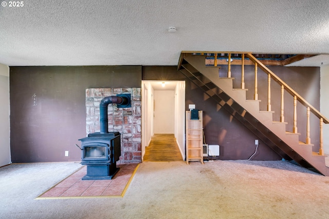 10303 SE Bull Run Rd, Corbett, OR 97019 - unfurnished living room featuring carpet floors, a textured ceiling, a wood stove, and stairs