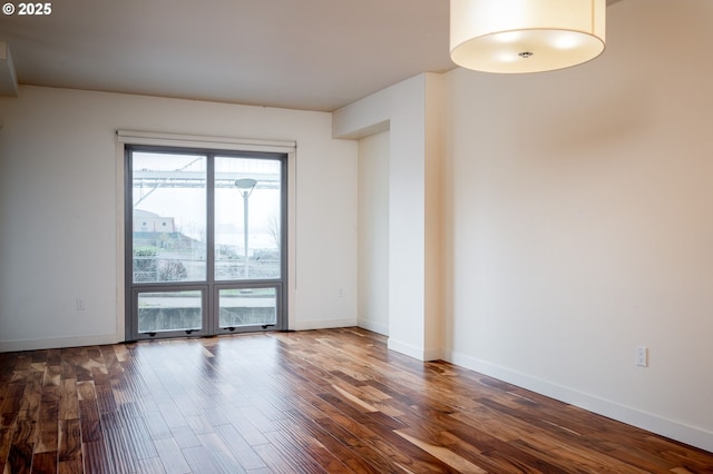 spare room featuring dark hardwood / wood-style flooring